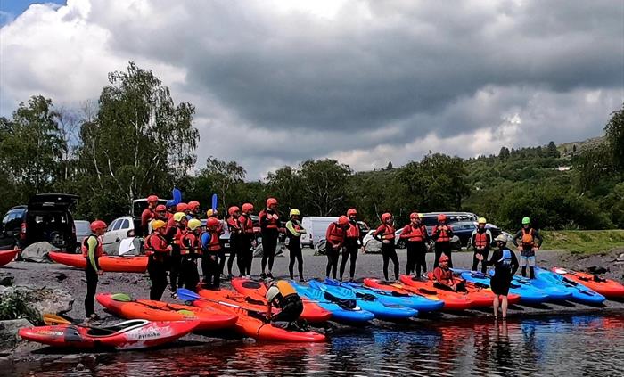 Large group of adults about to go kayaking on Llyn Padarn